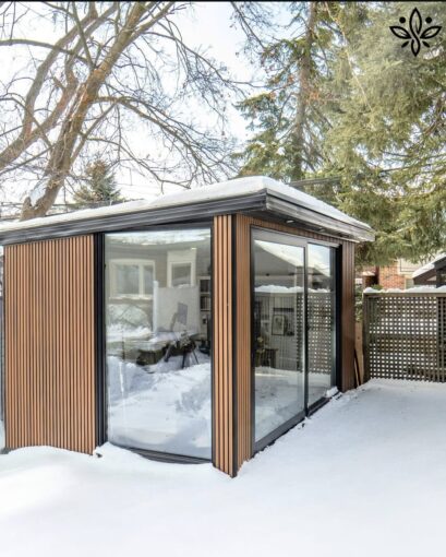Modern garden room with large windows, seamlessly blending with the outdoor space and offering a stylish, functional retreat