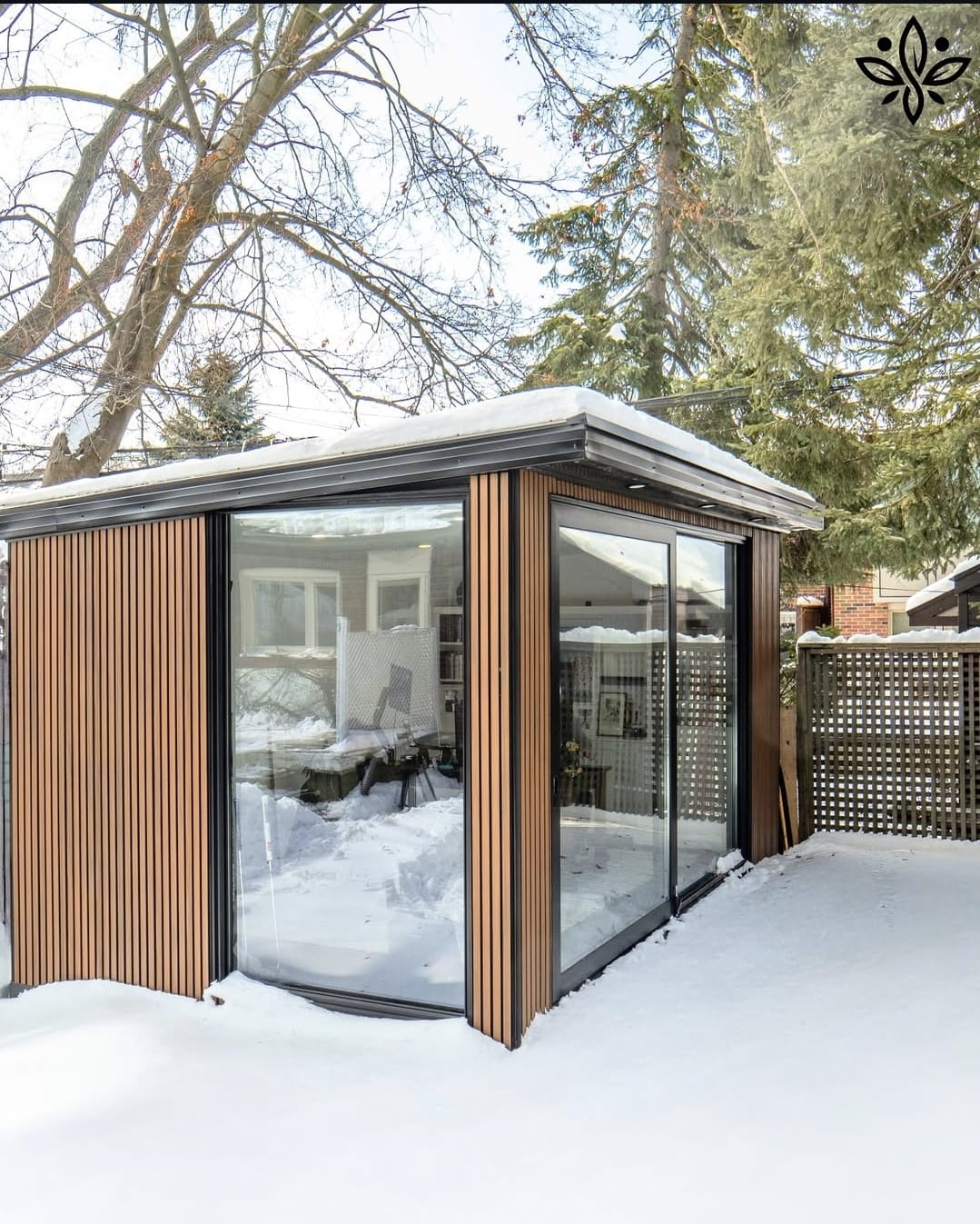 Modern garden room with large windows, seamlessly blending with the outdoor space and offering a stylish, functional retreat