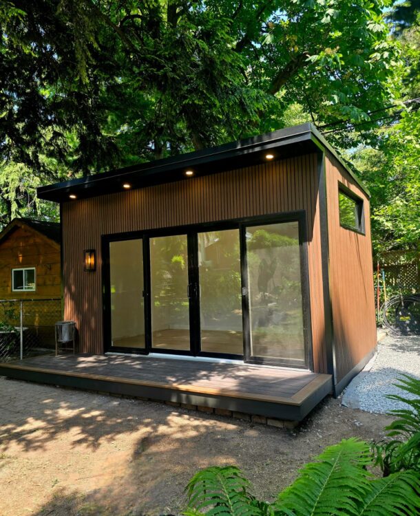 Modern custom garden room built on-site with large windows and all-season insulation.