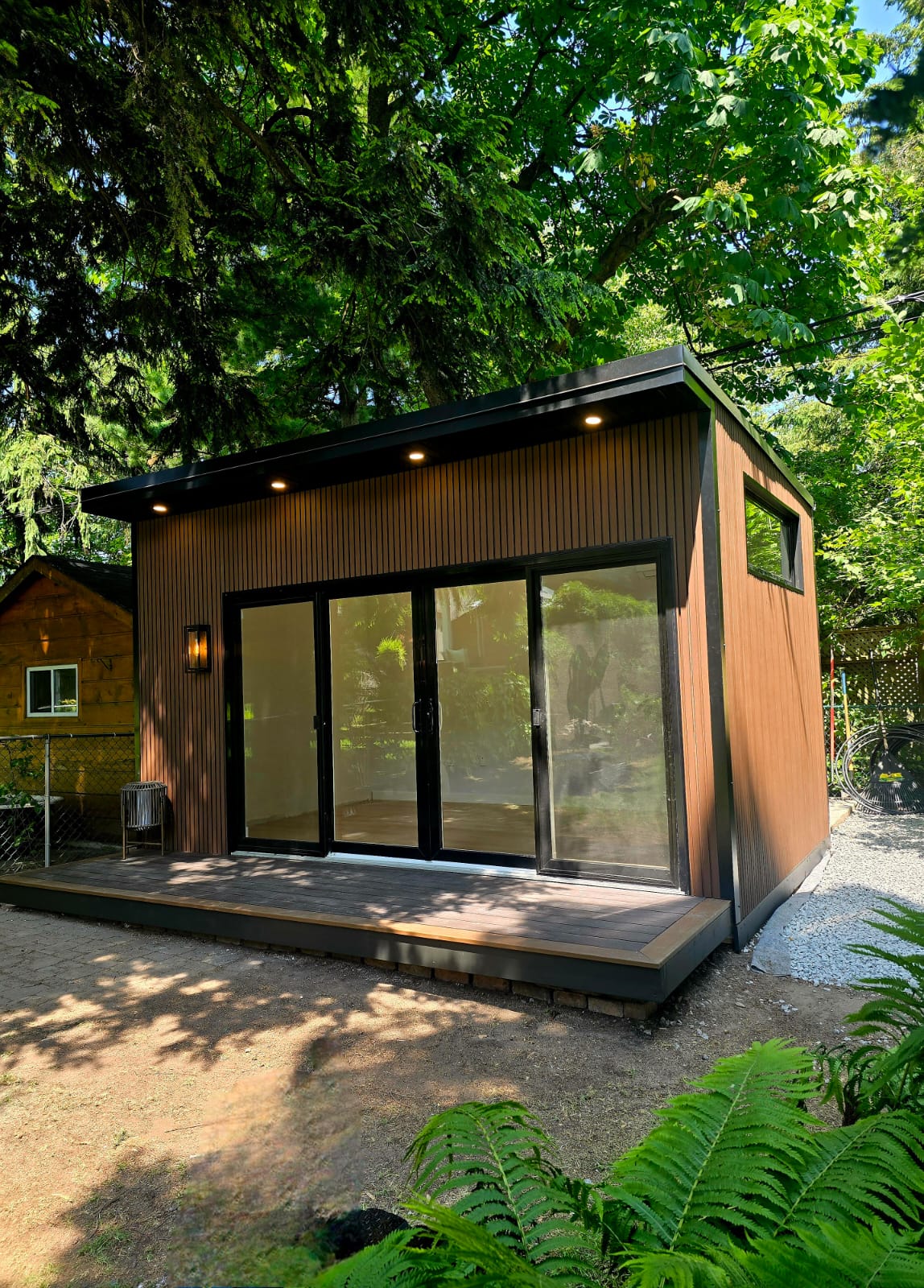 Modern custom garden room built on-site with large windows and all-season insulation.