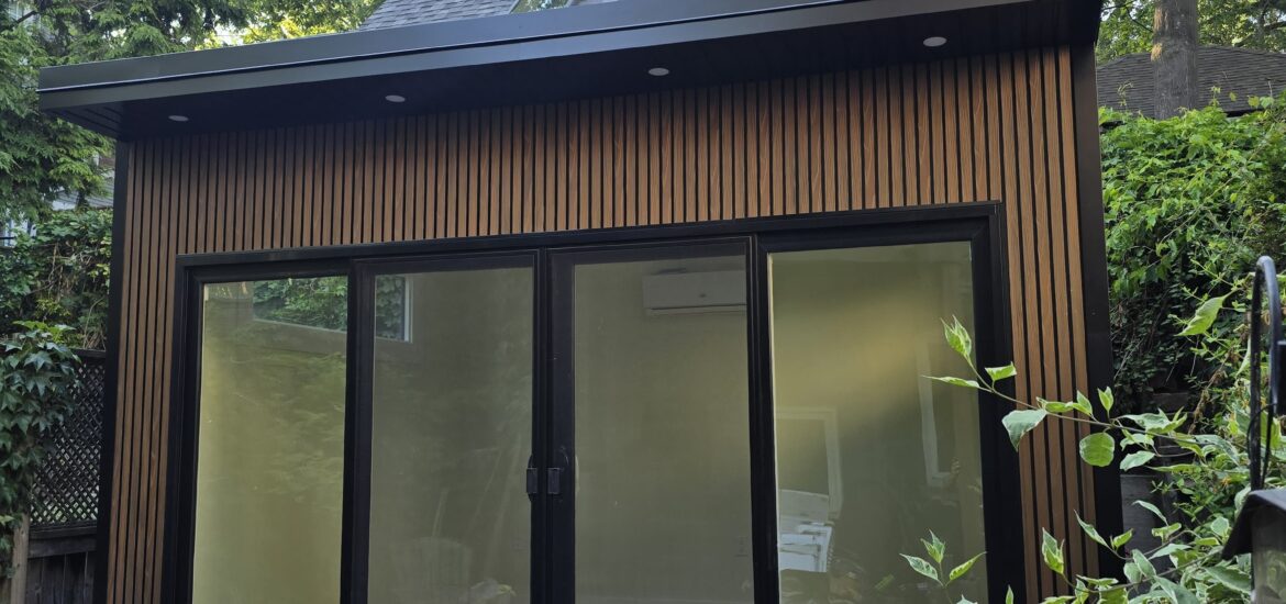 Modern custom garden room built on-site with large windows and insulated for year-round use