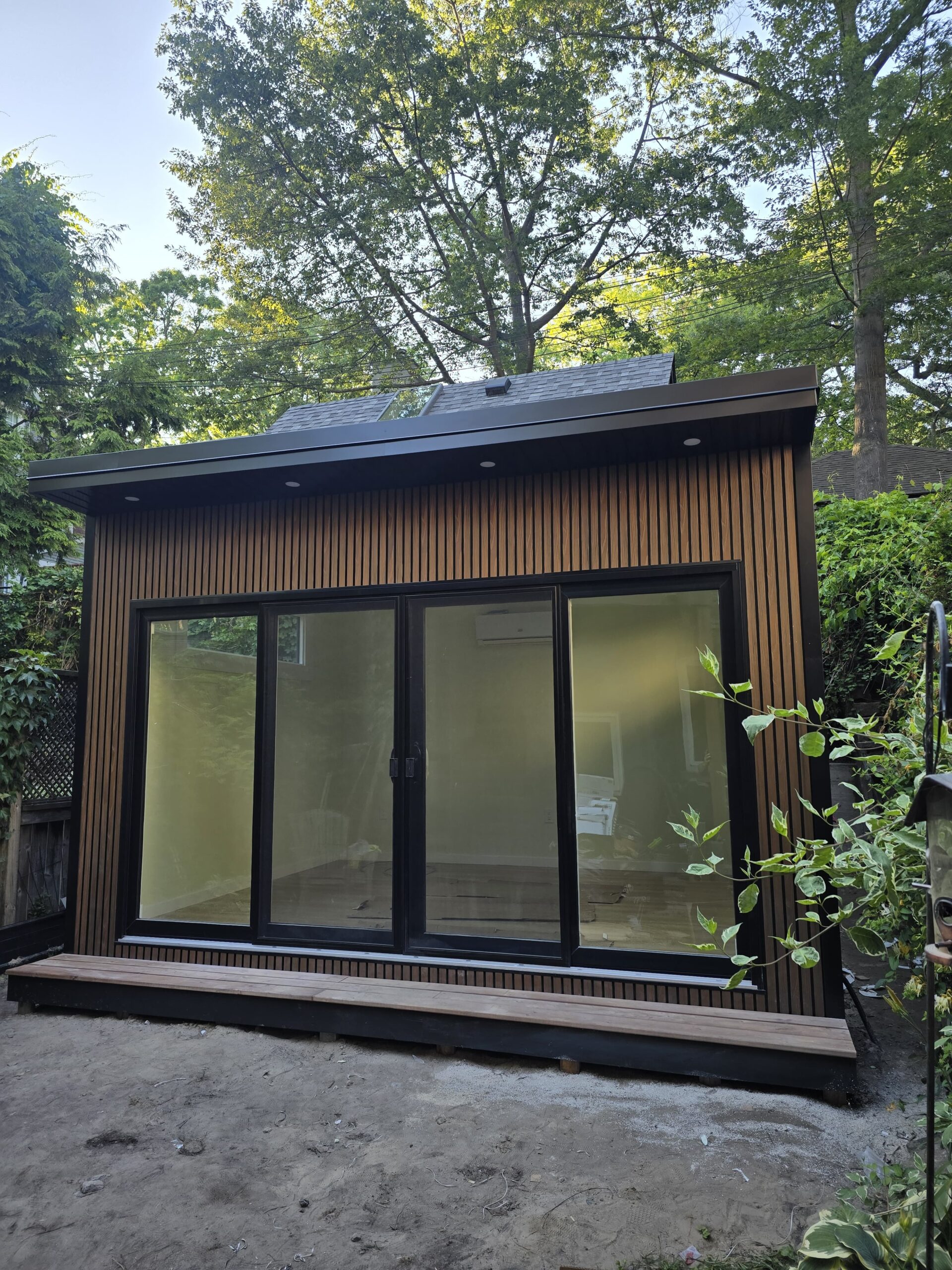 Modern custom garden room built on-site with large windows and insulated for year-round use
