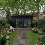 Modern backyard garden rooms with black corrugated metal siding